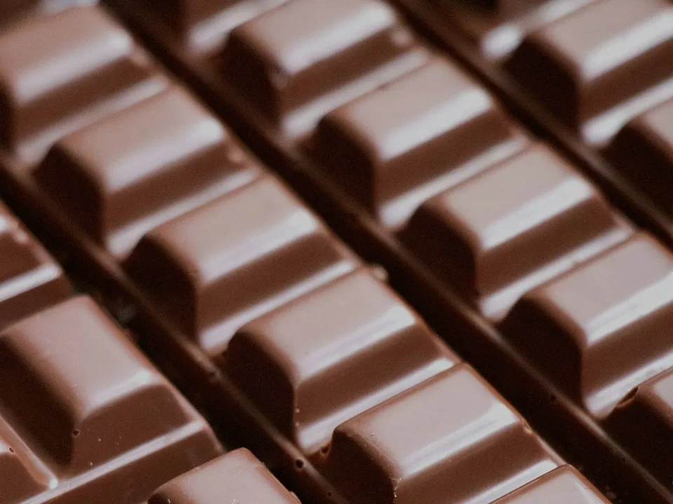 Close view of a tempered chocolate bar, its segments catching the light.